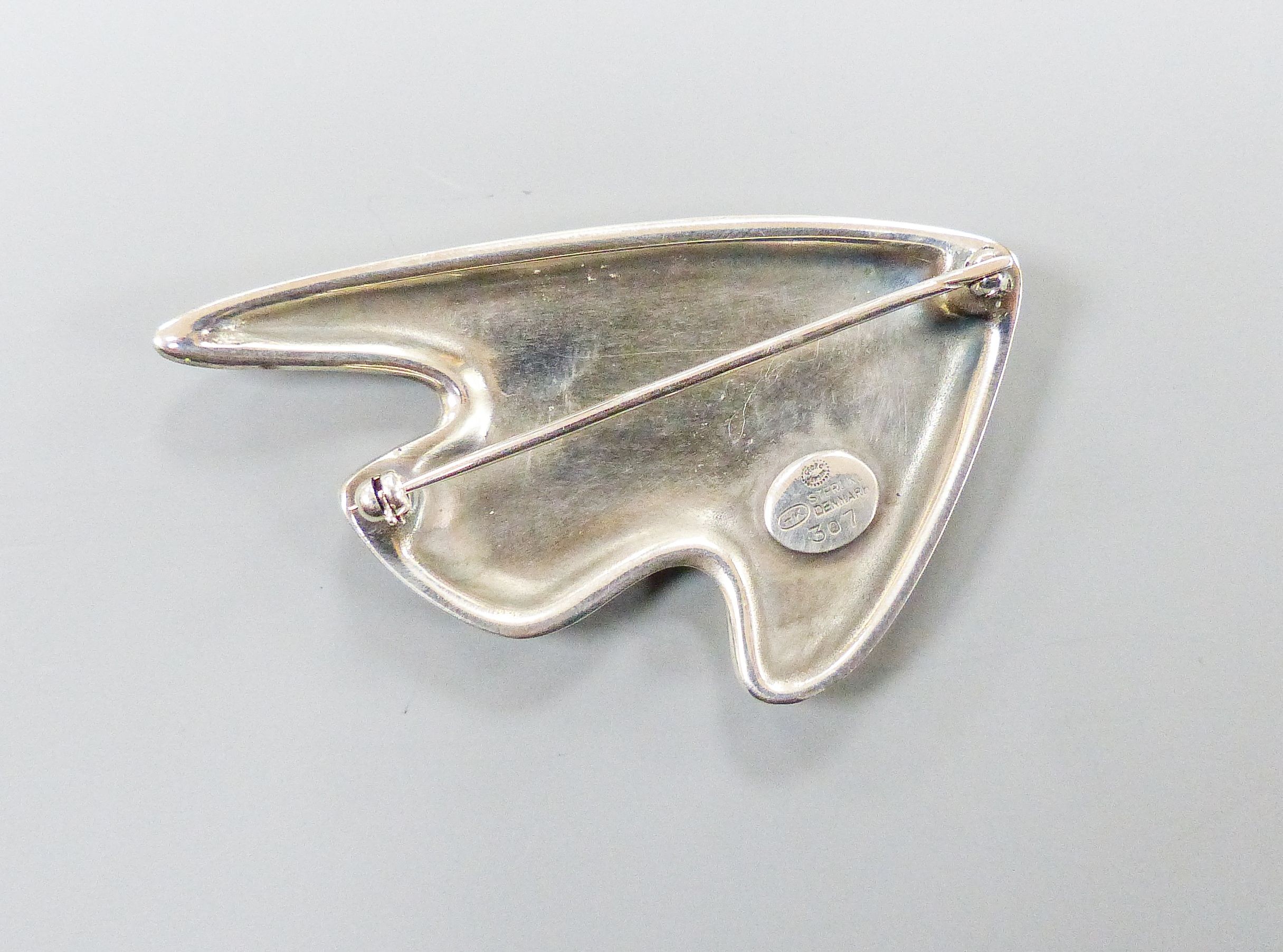 A Henning Koppel for Georg Jensen sterling and two colour mauve enamel stylised fish brooch, no. 307, 61mm.
